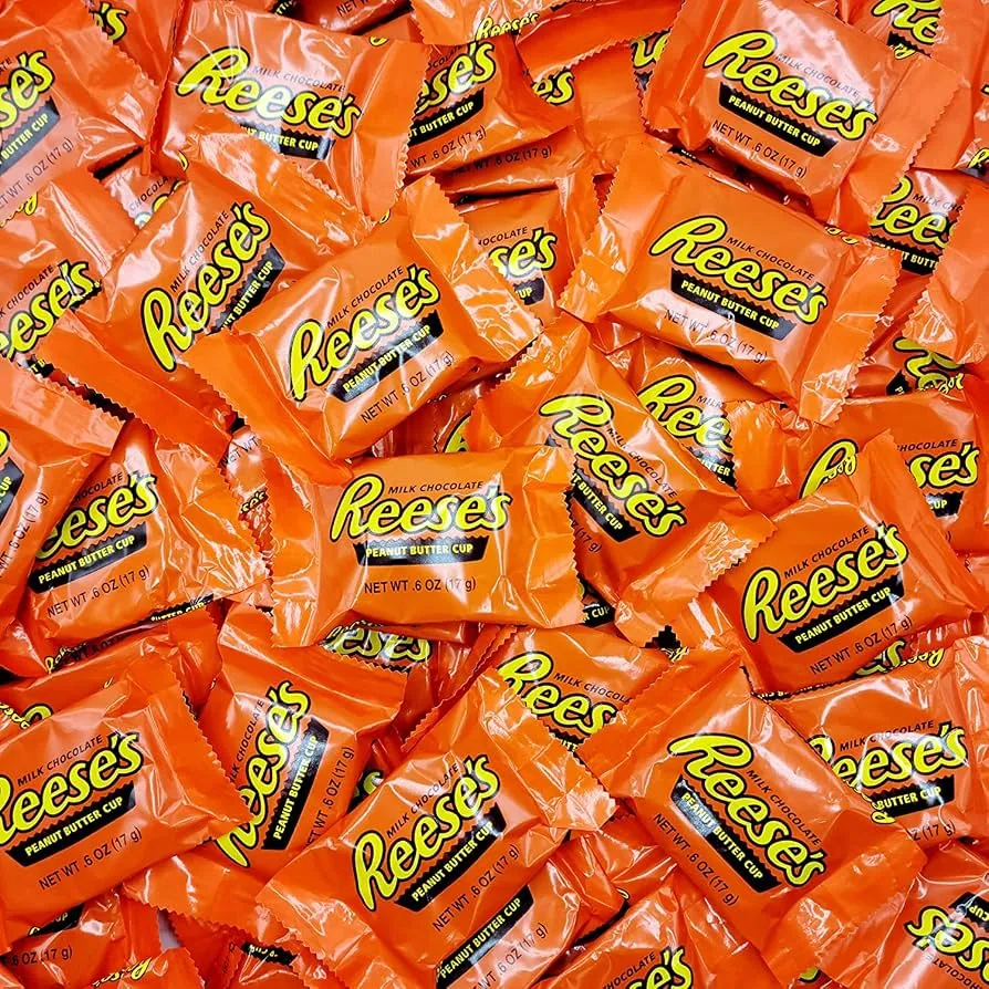 A pile of Reese's Peanut Butter Cups minis in orange wrappers